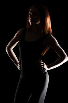 Light contour of a beautiful young woman with a red hair