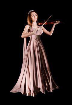 Pretty young woman playing a violin over black background