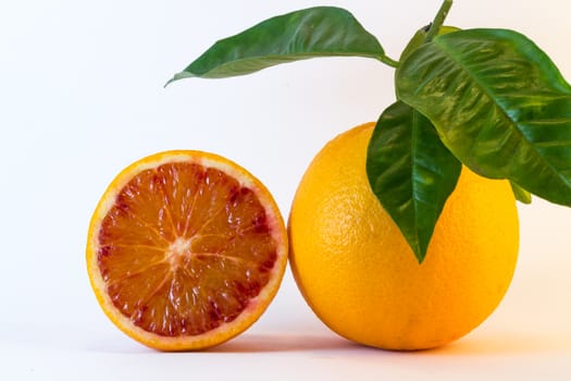 A Fresh Orange Fruit With A Half.