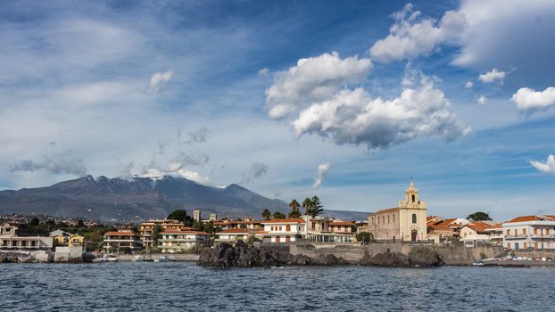 View of Sea port in sicily whit volcano Etna in background