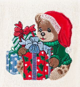 little brown bear with christmas hat and gift boxes hand embroidered on white towel