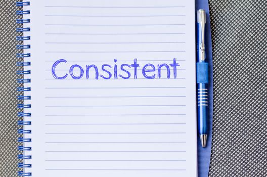 Consistent text concept write on notebook with pen