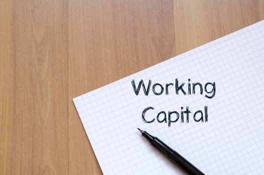 Working capital text concept write on notebook with pen