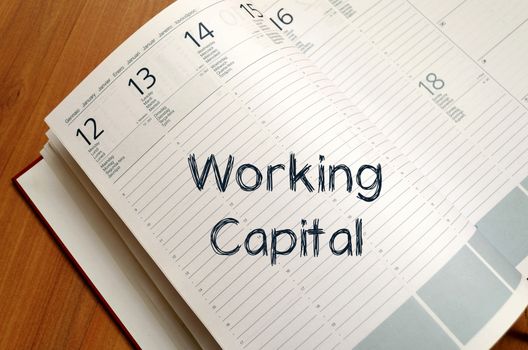 Working capital text concept write on notebook with pen