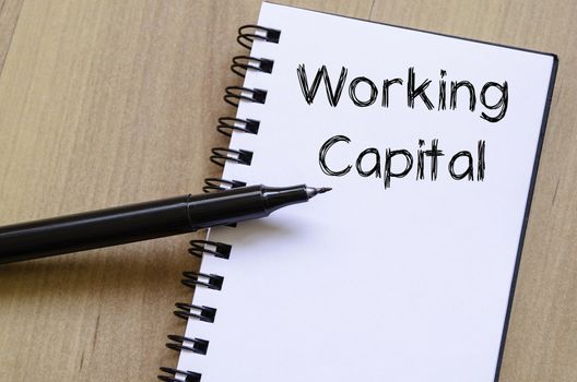 Working capital text concept write on notebook with pen