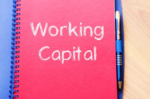 Working capital text concept write on notebook with pen