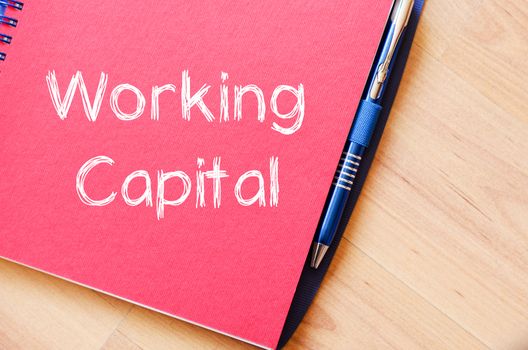 Working capital text concept write on notebook with pen