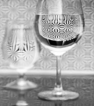 Glass with water refraction and reflection black white