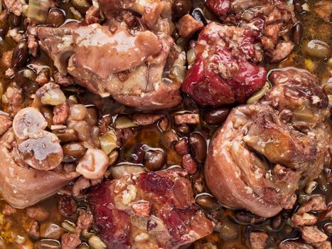 close up of rustic brazilian feijoada pork with black bean stew food background