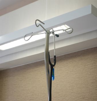 Stethoscope was hanging on medical metal stand in patient room.