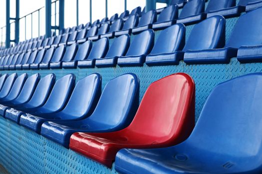 Empty plastic seats at stadium, open door sports arena.