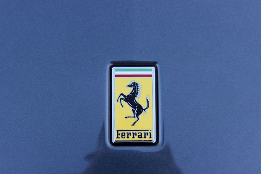Monte-Carlo - JAN 12 :  Logo of Ferrari on the blue sport car Ferrari parked in front of Casino, south of France on January 12, 2016 in Monte-Carlo, Monaco