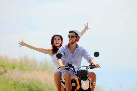 Happy couple on a scooter at summer vacation