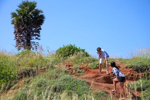 Young couple hiking on top of hill on vacation