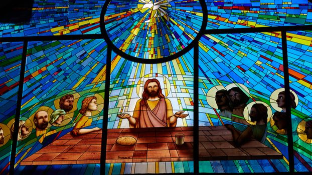 Sorrento, Italy - November 8, 2013: Stained glass window depicting Jesus and the twelve apostles on maundy thursday at the Last Supper in the cathedral