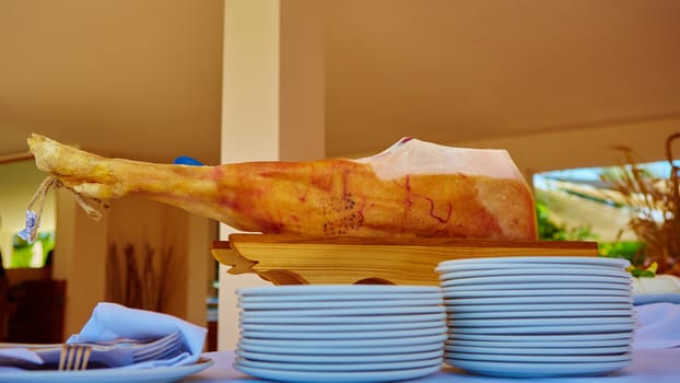 Slicing of italian dry-cured ham prosciutto. Toned image. Selective focus point