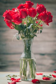 Valentines Day of Red rose in vase on wooden background
