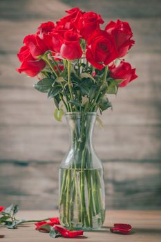 Valentines Day of Red rose in vase on wooden background