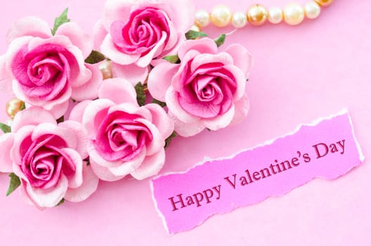 Happy valentine's day text card with pink rose on pink background.
