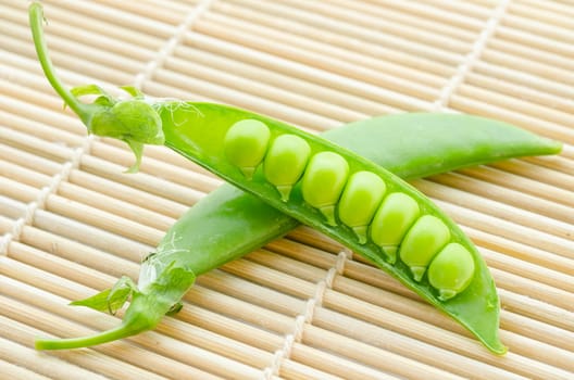 resh green peas vegetable on mat wood board