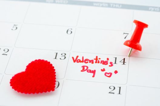 Calender page with a detail of the valentine day with red heart.
