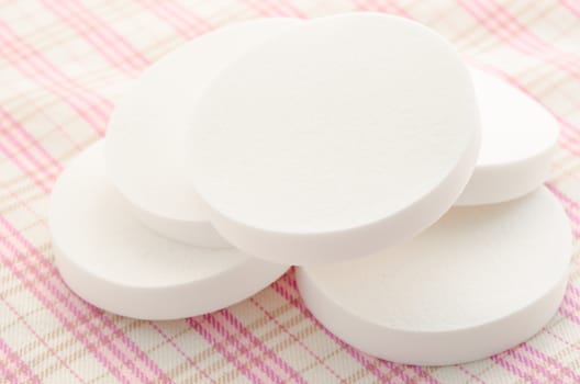 Cosmetic sponges makeup on fabric background