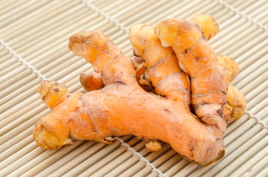 Group of turmeric on grunge mat wooden.