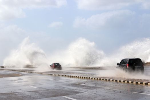 CUBA, La Havana: Vehicles drive through the flooded Malecon seawall in La Havana, Cuba, on January 17, 2016. Heavy seas invaded the Havana coastline along the Malecon seawall. 