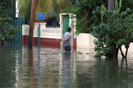 CUBA, La Havana: A man wades through a flooded street in La Havana, Cuba, on January 17, 2016. Heavy seas invaded the Havana coastline along the Malecon seawall. 