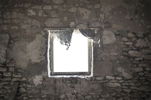 Looking through the window from the ruins of an old stone building