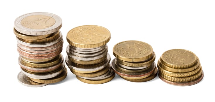 Four stacks of gold coins isolated on white background, close up view