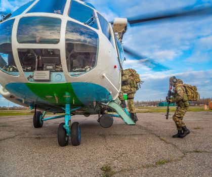 Odessa, Ukraine - December 02, 2015: Special Forces soldiers are loaded into the helicopter with the engine running at the heliport