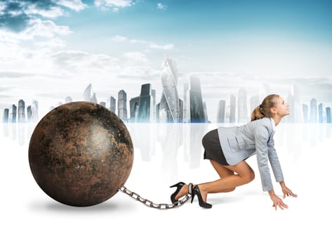 Businesswoman with iron ball isolated on cityscape background, side view