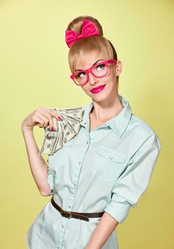 Beauty fashion. Money, banking finance concept. Surprised business woman with dollar bill, cash. Shocked, confidence Pinup hairstyle bow,glasses. Unusual playful, emotion. Shopping girl thinking idea