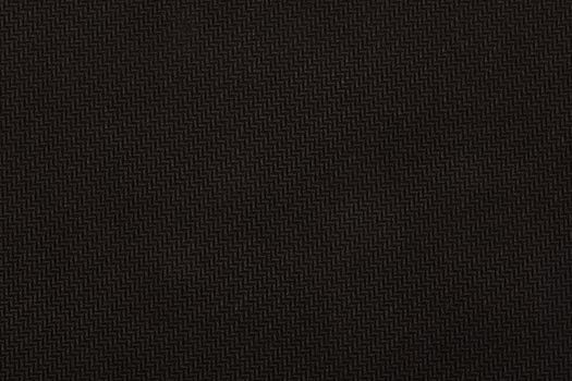 Black material with geometric patterns, a background or texture