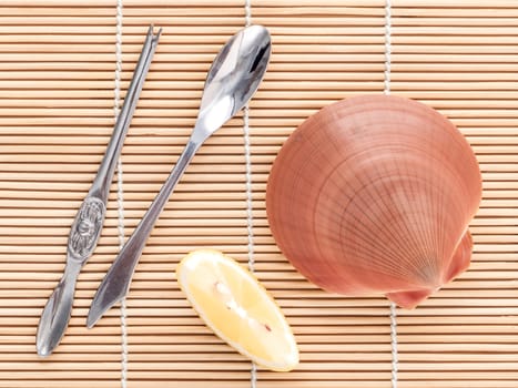 Raw queen scallops with lemon slice ,fork and spoon preparing for grill top view composition.