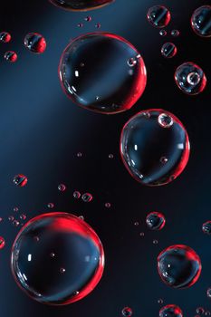 Abstract red and black background with various water drops