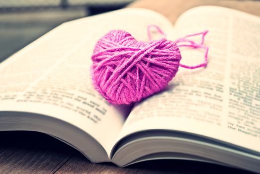 pink heart knitting wool put on the book, for valentine's day