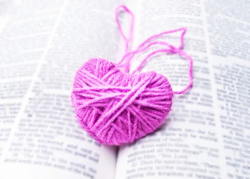 pink heart knitting wool put on the book, for valentine's day