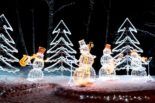 The photo shows Snowmen playing musical instruments