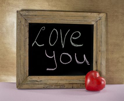 blackboard with text I love you and red heart 