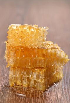 honeycombs with honey on wooden background
