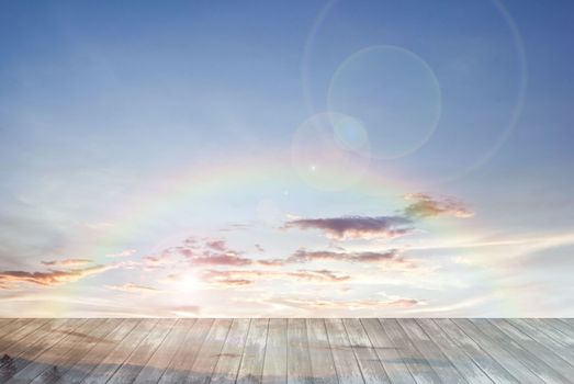 old wooden texture and rainbow with lens flare in blue sky background