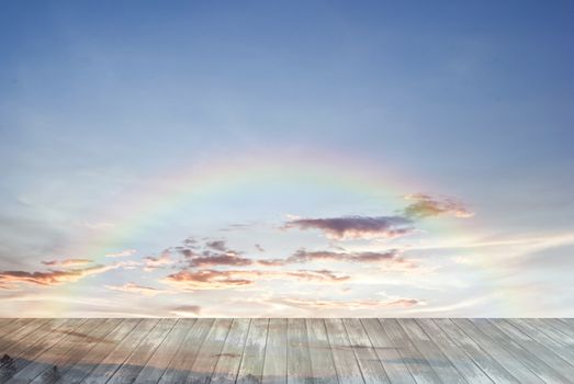 old wooden texture and rainbow in blue sky background