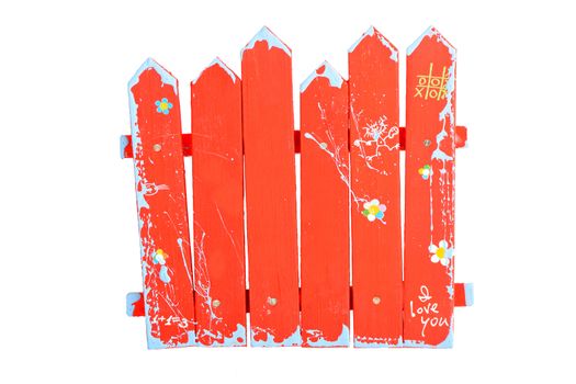 Red wooden souvenir handmade painted fence isolated on white