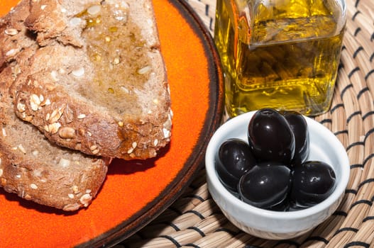 Slices of rye bread with oil and black olives