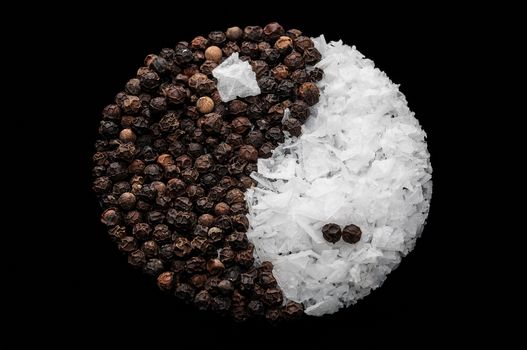 Maldon salt and peppercorns forming the yin yang circle