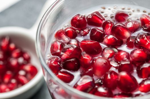 Seeds of pomegranate on a slate background