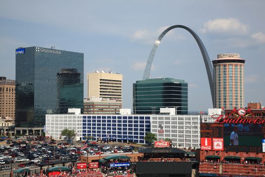 Fans gather for a late season Cardinals game at Busch Stadium, under the Gateway Arch.