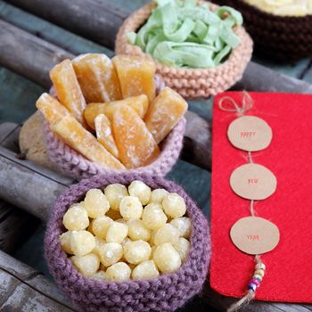 Vietnamese food for Tet holiday in spring, jam is traditional food on lunar new year, can make from sweet potato, lotus seed, ginger with suger, colorful background for Vietnam custom